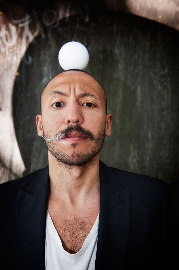 Juggler Jorge Petit two toned mustache and  a ball on his head