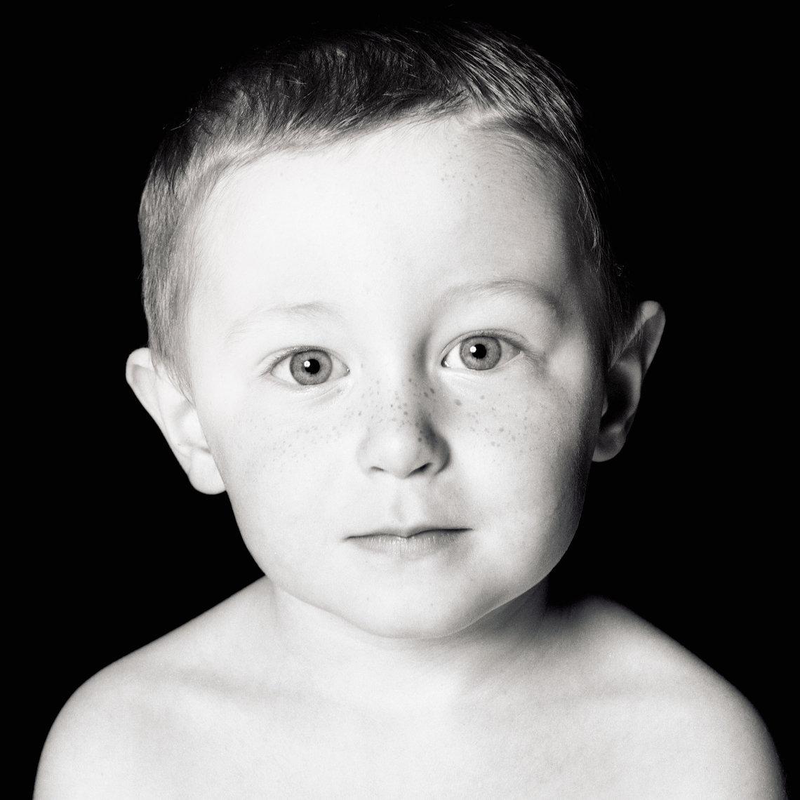 Young Caucasian boy with big blue eyes black and white portrait