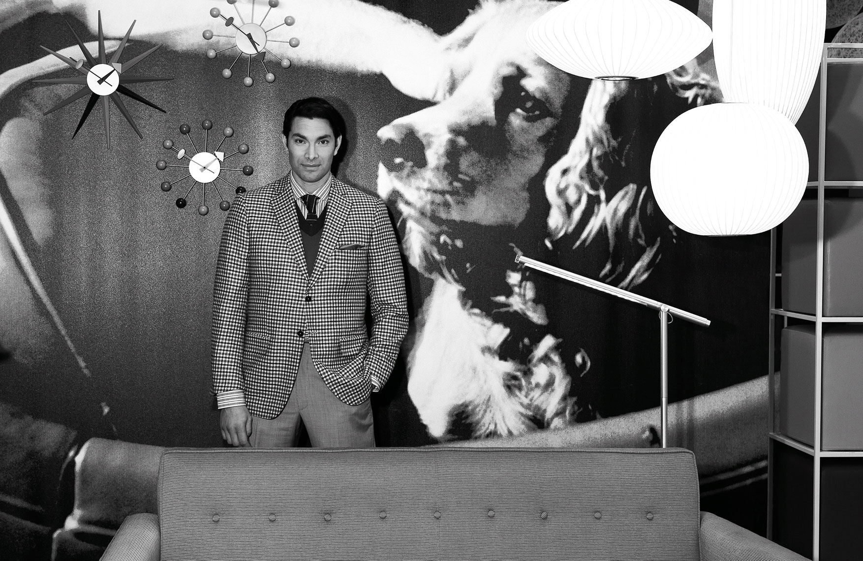 Suited man with eames furniture and background black and white