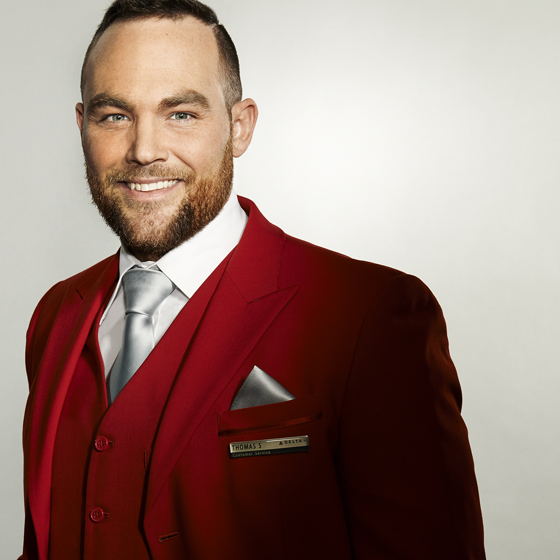 Delta Red Coat Caucasian man silver tie