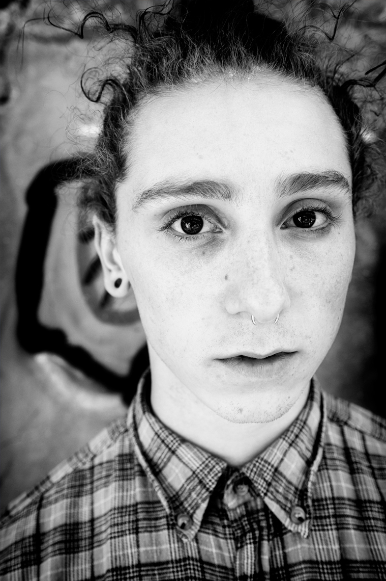 Nate Armour Young man with big eyes and freckles_black and white portrait on graffiti background