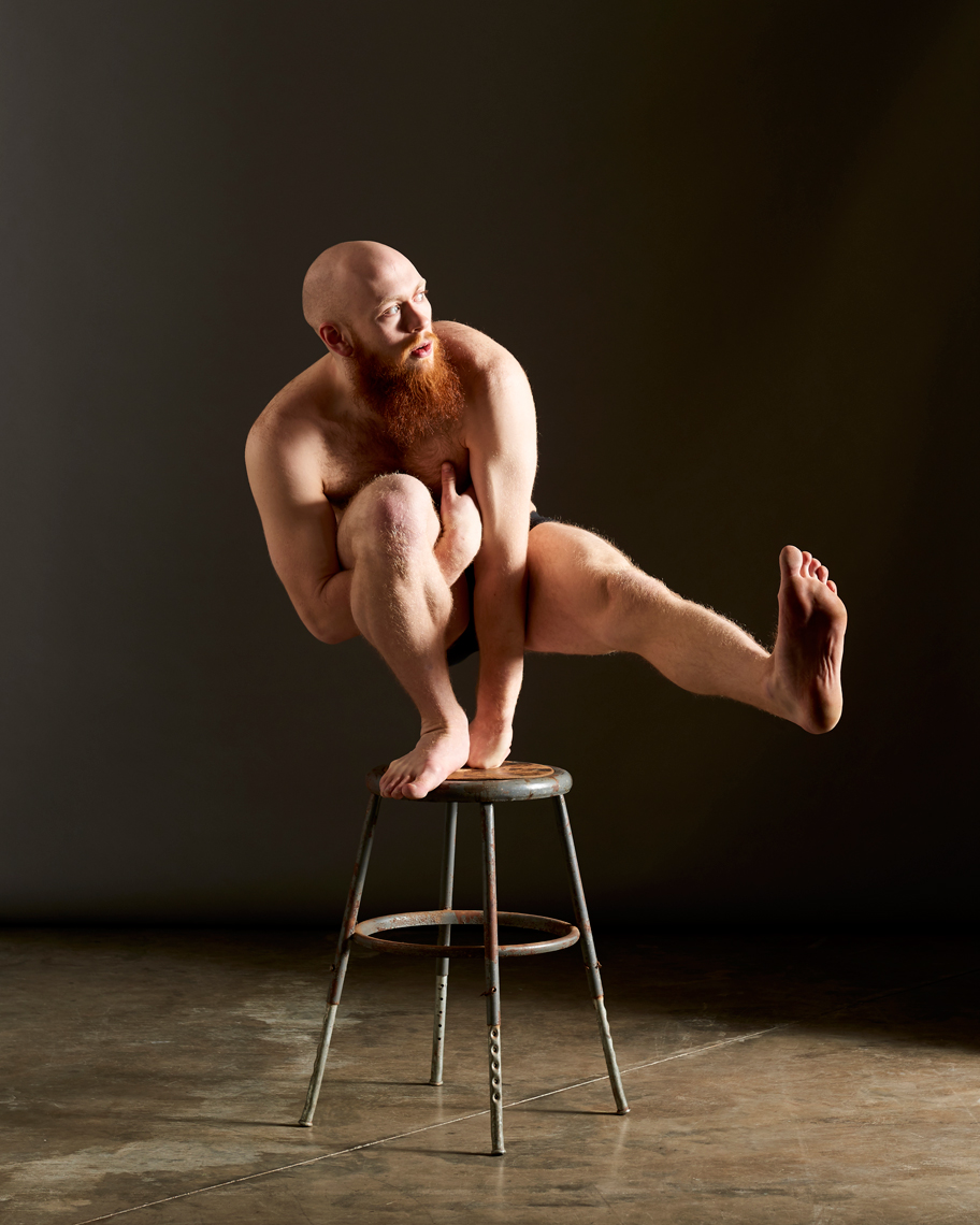 Cooper in Balance Stool Skin Bald Circus